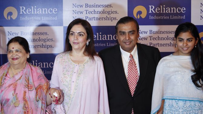 Mukesh Ambani, chairman of Reliance Industries Limited, poses with his mother Kokilaben Ambani (L), wife Nita Ambani (C) and daughter Isha Ambani (R)