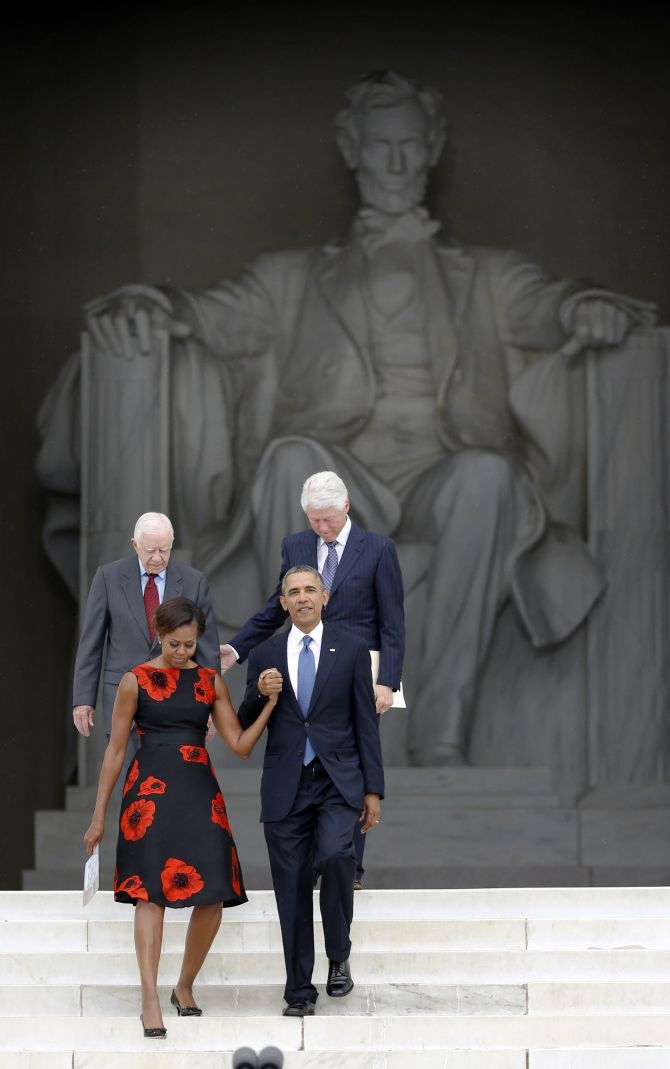 United States President Barack Obama leads first lady Michelle Obama and former presidents Jimmy Carter (L) and Bill Clinton