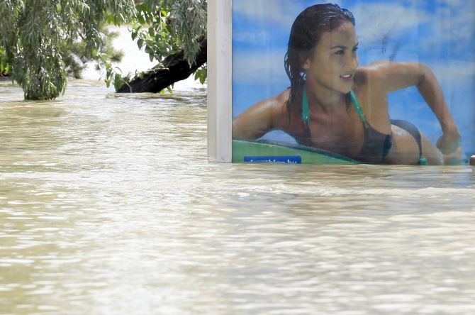 A partially submerged billboard on a tramstop is seen on the flooded embankments of the Danube River in Budapest, Hungary, in June, 2013